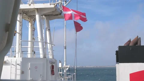 Danish flag located on ship waves in strong wind at port Stock Footage 135443400