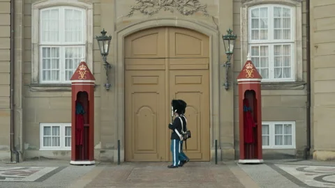 Danish Royal Life Guards pace post and stand guard outside Amalienborg Palace Stock Footage 345037820