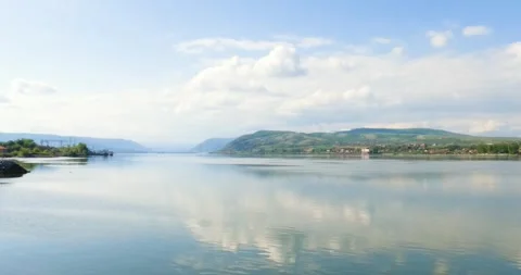 Danube Reflections: Serene Waters Mirror Sky and Hills in Serbia Stock Footage 303975888
