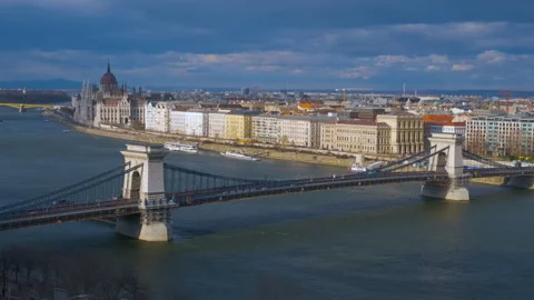 Danube river with chain bridge under sun. Video stock 253729409