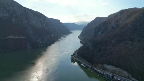 Danube river flowing between steep cliffs , in western Romania , aerial view Stock-Footage 300952976