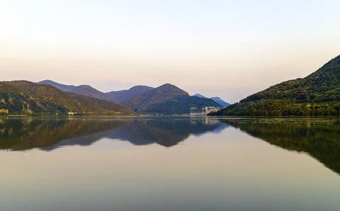 The Danube river at sunset with the reflection of the hills in the water Stock Photos