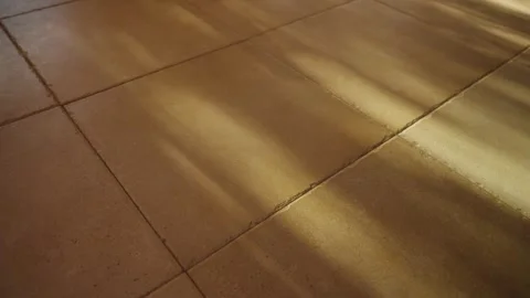 Dappled light from sun shining on floor tiles inside home or apartment Stock Footage 316073346