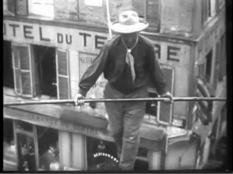 Daredevil tightrope walker steps across rope vintage archival footage Stock Footage 86326301