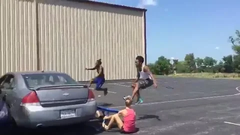 Daredevils leapfrog over three cars in Ohio parking lot Stock Footage 273011241