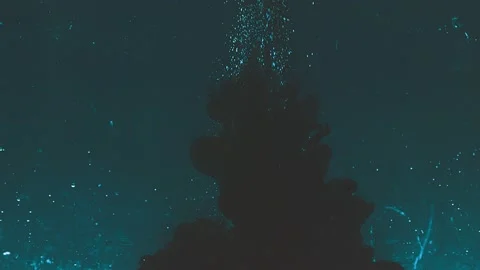 Dark abstract background. Black ink drops in water Stock Footage 136233497