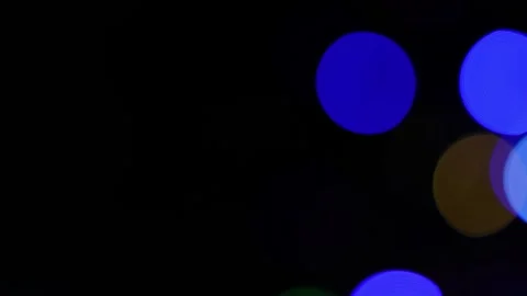 Dark abstract background with colorful out of focus light circles on the ri.. Видео 337898975