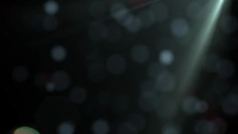 A dark abstract background with a soft bokeh effect and a subtle spotlight. Stock Footage 314060308