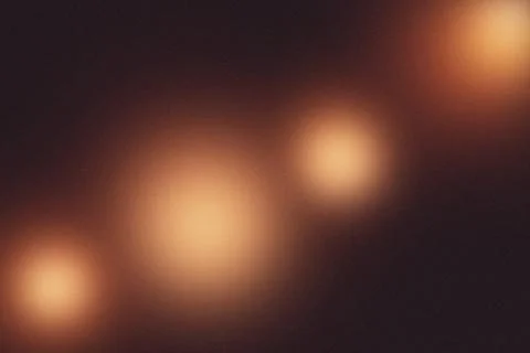 Dark abstract background with warm glowing blurred light orbs and film grai.. Stock-Fotos