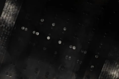 Dark abstract optical texture with scattered silver bokeh and blurred mesh .. Stock Photos