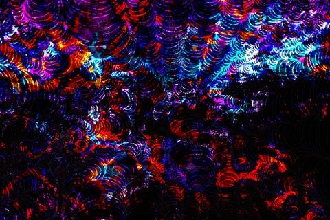 Dark abstract pattern with concentric curved waves in red, blue, and black Stock Photos