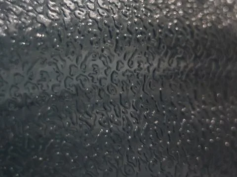 Dark Abstract Textured Surface with Reflective Highlights Stock Photos
