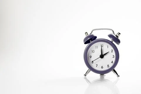 Dark alarm clock with shadow and space for your presentation text. Stock Photos