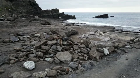 Dark and black beach due to its use as waste tank. Cabo Negro, Asturias. Stock Footage 135956376