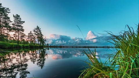 Dark and dramatic thundercloud over the lake at sunrise, sunset, reflected in Stock Footage 138998569