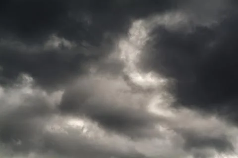 Dark and gray clouds formations in the sky. Only sky image, no land. Stock Photos