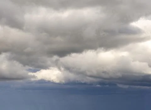 Dark and gray clouds formations in the sky. Only sky image, no land. Stock Photos