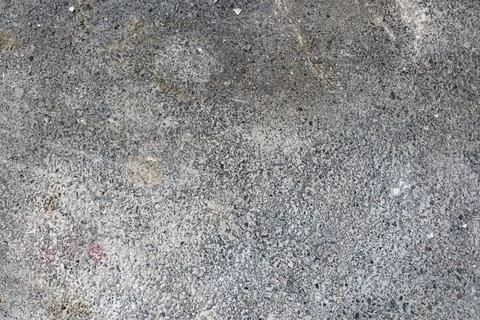 Dark and gritty concrete surface with soft gradients and subtle discoloration. Stock Photos