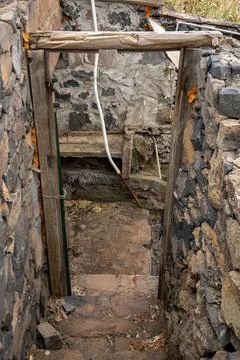 Dark and Gritty Stone Steps Descend into an Obscure and Weathered Cellar En.. Stock Photos