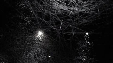 A dark and intricate web of tangled threads, illuminated by eerie glowing lights Stock Footage 304357652