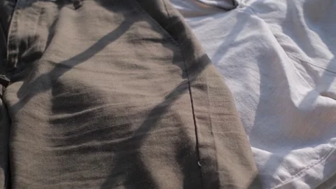 Dark and light clothes made of natural linen, close-up Video stock 311772107