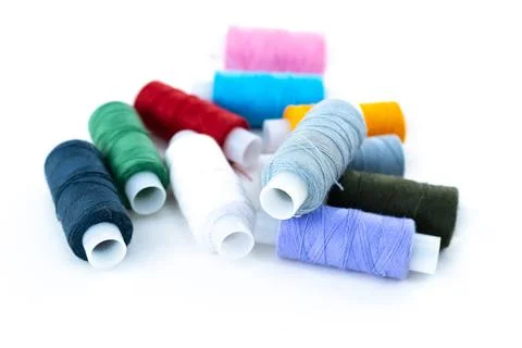 Dark and light threads for needlework blue, gray, red on an isolated backgrou Stock Photos