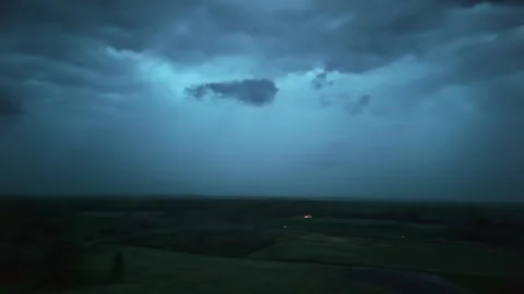 Dark and powerful storm clouds with thunder above a countryside landscape Stock Footage 308760655