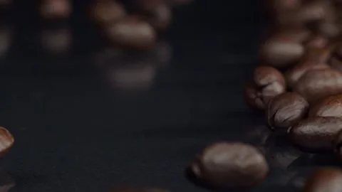 Dark and Refined. Slow motion shot of roasted brown coffee beans rolling 스톡 동영상 150559964