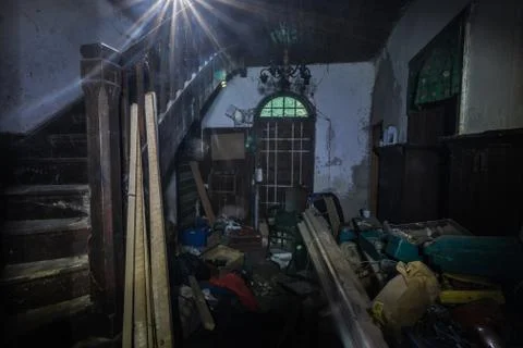 Dark anteroom with objects and light from the attic Stock Photos