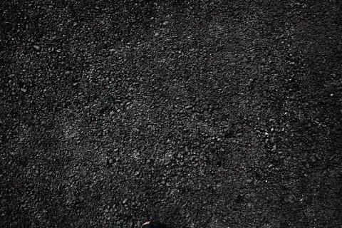 Dark asphalt roadbed. Stock Photos