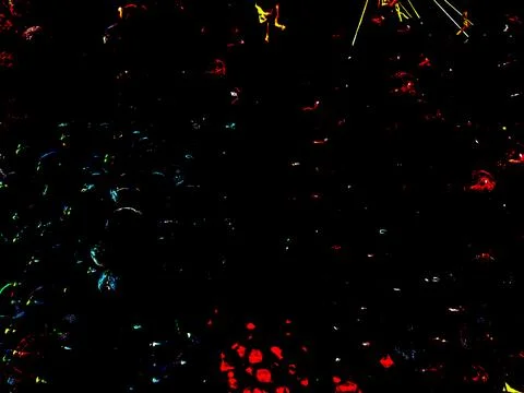Dark backdrop showcases luminous splashes of red, blue, and yellow, creating  Foto stock