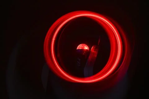 The dark background is an abstraction of red circles. 스톡 사진