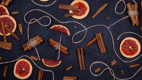 Dark background with candied, dried oranges, cinnamon Stock Footage 166682860