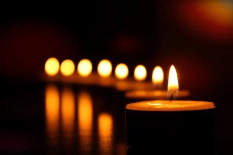 Dark background of candle lights with selective focus Stock Photos