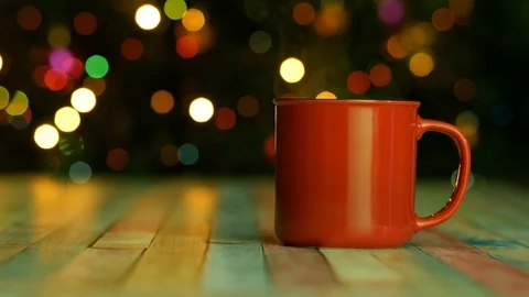 Dark background with flashing lights and a mug of hot drink Video stock 122688833