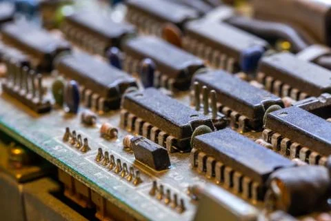 Dark background of old electronic circuit board closeup with dus Fotos Stock