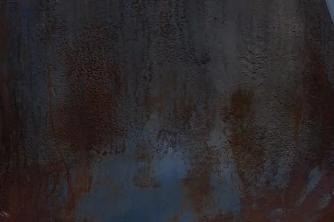 Dark background of oxidized copper with rust spots. Texture, wallpaper, pattern. Stock Photos