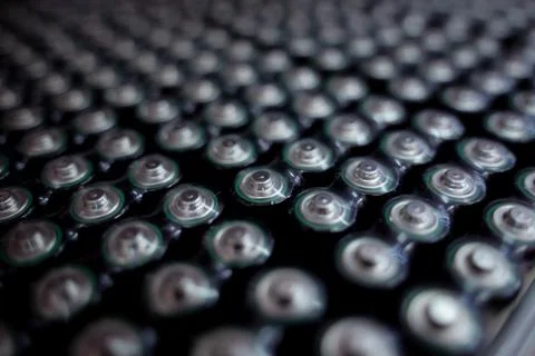 Dark background of rows of new batteries Foto stock