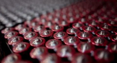 Dark background of rows of new batteries Foto stock