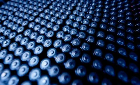 Dark background of rows of new batteries Foto stock