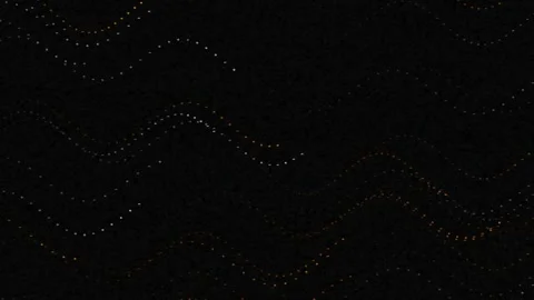 Dark background with shimmering abstract wave patterns of tiny golden dots Stock Footage 329951672