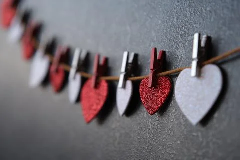 On a dark background on a string of hearts Stock Photos