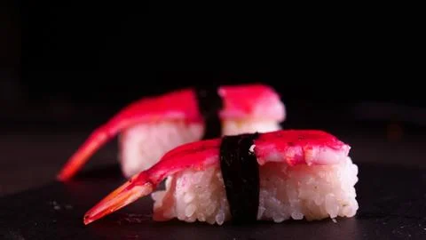 On a dark background on a tray, cooked or purchased sushi (Nigiri) Stock Photos