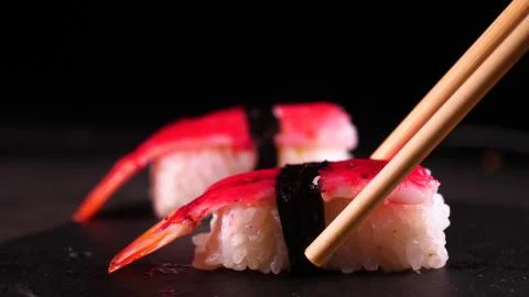 On a dark background on a tray, cooked or purchased sushi (Nigiri) Stock Photos