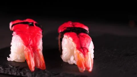 On a dark background on a tray, cooked or purchased sushi (Nigiri) Stock Photos