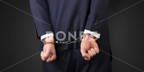 Dark backgrounded close handcuffed man Stock Photos