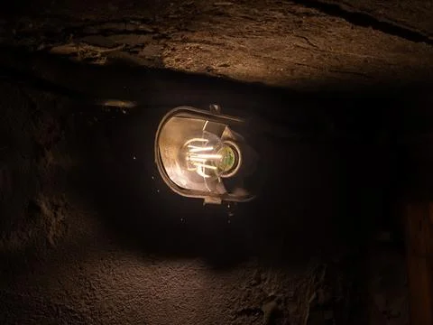 Dark basement LED lamp weak lighting single light Stock Photos