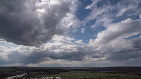 Dark beautiful clouds, dramatic sky over a beautiful valley. The clouds are Stock Footage 244825590