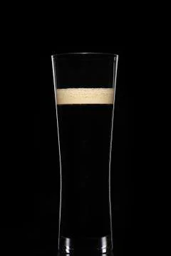 Dark beer on a black background Stock Photos