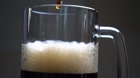 Dark beer close-up. a stream of beer slow motion Stock Footage 135413821